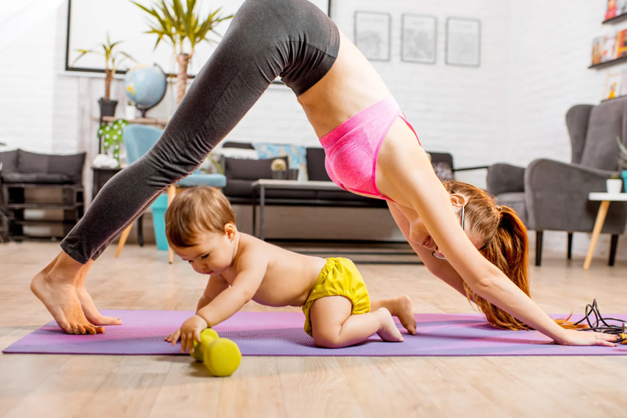 Mom after body sculpting holding her baby, showing confidence and post-baby balance