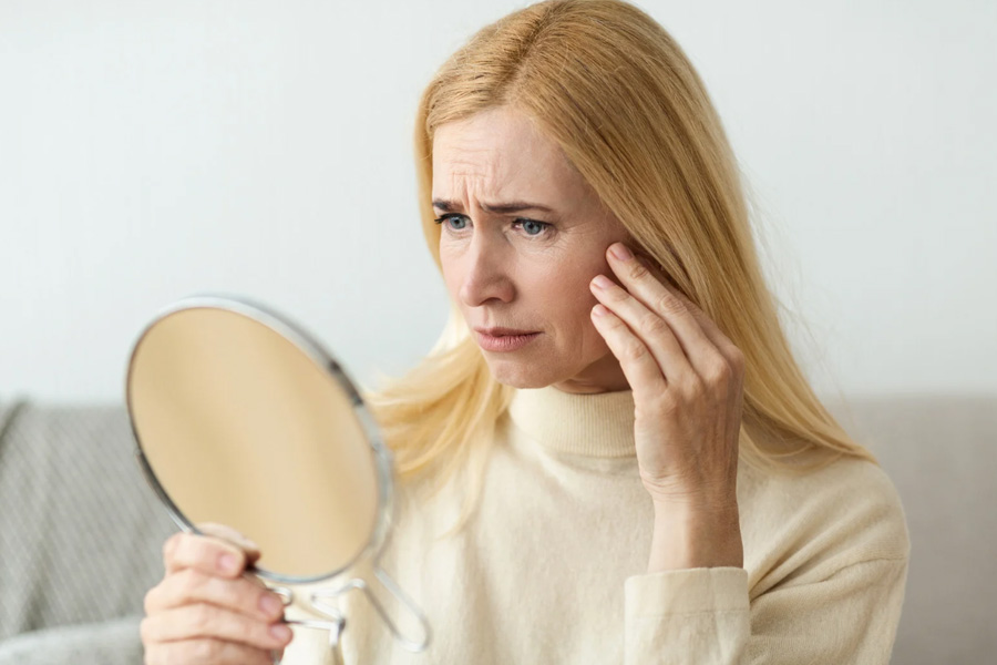 A woman checking her face that needs a wrinkle treatment hilton head