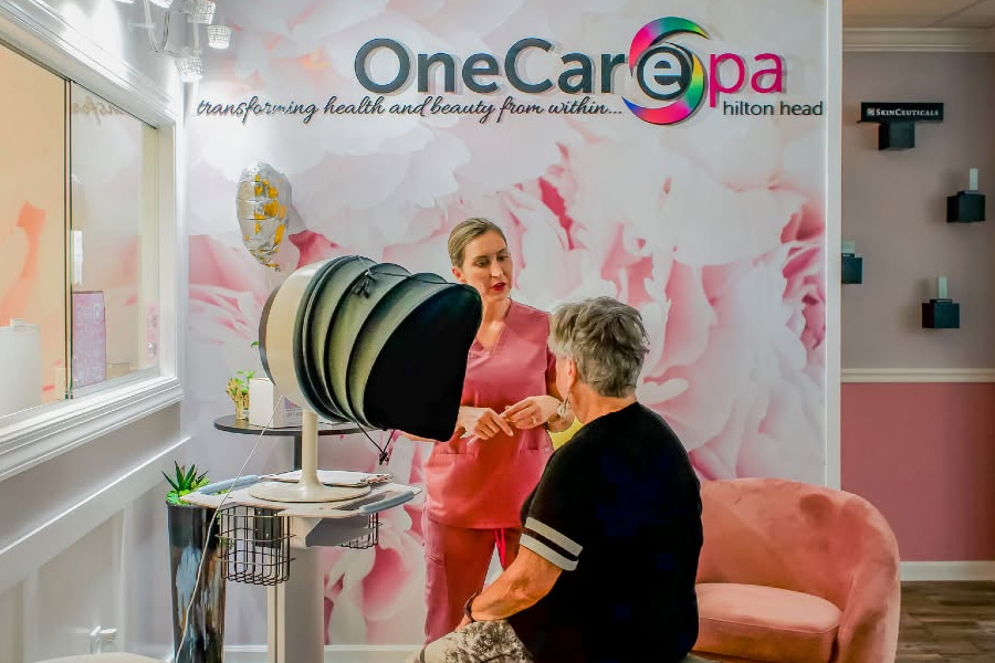 Licensed aesthetic provider discussing personalized photorejuvenation treatment considerations with a patient in a modern medical spa consultation room.